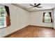 Bedroom with hardwood floors, neutral walls, and two windows with dark shutters at 1745 Shady Hill Ne Rd, Marietta, GA 30068