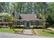 Inviting home featuring a manicured lawn, brick walkway, and dormer windows at 1745 Shady Hill Ne Rd, Marietta, GA 30068