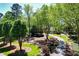 The exterior of the house features a circular driveway, mature trees, and beautiful landscaping at 1745 Shady Hill Ne Rd, Marietta, GA 30068