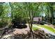 Charming one-story home with lush landscaping and a winding gravel driveway at 1745 Shady Hill Ne Rd, Marietta, GA 30068