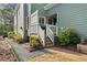 View of home's charming side entrance with stairs, light green siding, and blossoming azalea bushes at 2964 Anderson Se Cir, Smyrna, GA 30080