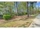 View of a peaceful backyard featuring a wooden swing under a charming pergola surrounded by tall trees at 2964 Anderson Se Cir, Smyrna, GA 30080