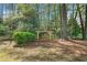 Relaxing backyard featuring a wooden swing under a charming pergola, surrounded by lush greenery at 2964 Anderson Se Cir, Smyrna, GA 30080