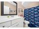 Cozy bathroom featuring a framed mirror, a Patriots-themed shower curtain, and great lighting at 2964 Anderson Se Cir, Smyrna, GA 30080