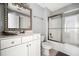 Clean bathroom with vanity, mirror, and bathtub with sliding glass doors at 2964 Anderson Se Cir, Smyrna, GA 30080