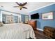 This primary bedroom offers wood floors, a ceiling fan and is bathed in natural light at 2964 Anderson Se Cir, Smyrna, GA 30080