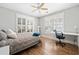 Bright bedroom with hardwood floors, shutters, ceiling fan, and a cozy bed at 2964 Anderson Se Cir, Smyrna, GA 30080