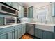 Modern kitchen features blue cabinets, stainless steel appliances, and bright backsplash at 2964 Anderson Se Cir, Smyrna, GA 30080