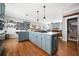 Spacious kitchen with hardwood floors, island with gas cooktop, and open shelving at 2964 Anderson Se Cir, Smyrna, GA 30080