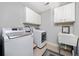 Functional laundry room with washer, dryer, sink, and ample cabinet space at 2964 Anderson Se Cir, Smyrna, GA 30080