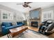 Inviting living room features a stone fireplace, large windows, and hardwood floors, bathed in natural light at 2964 Anderson Se Cir, Smyrna, GA 30080