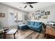 Cozy living room featuring a plush blue sofa, ceiling fan, and hardwood floors at 2964 Anderson Se Cir, Smyrna, GA 30080