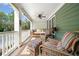 Relaxing covered porch with wicker furniture, ceiling fan, and swing, ideal for enjoying the outdoors at 2964 Anderson Se Cir, Smyrna, GA 30080