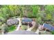 Aerial view of a brick home with mature trees and lush landscaping, offering privacy at 3045 Hartridge Dr, Johns Creek, GA 30022