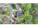 An aerial view showcases the property's landscaped yard and wooded surroundings at 3045 Hartridge Dr, Johns Creek, GA 30022