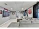 Entertainment area in finished basement with a large TV and sectional couch at 3045 Hartridge Dr, Johns Creek, GA 30022