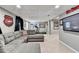 Finished basement with grey sectional and entertainment system, and a treadmill at 3045 Hartridge Dr, Johns Creek, GA 30022