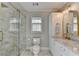 Beautiful bathroom with glass shower, marble floors, new vanity, and soft lighting at 3045 Hartridge Dr, Johns Creek, GA 30022