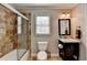 Well-lit bathroom with a glass-enclosed shower, dark wood vanity, and neutral tones at 3045 Hartridge Dr, Johns Creek, GA 30022