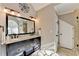 Elegant bathroom features a double vanity with granite countertop and decorative wall accents at 3045 Hartridge Dr, Johns Creek, GA 30022