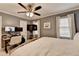 Comfortable bedroom featuring a ceiling fan, natural light, and a practical workspace at 3045 Hartridge Dr, Johns Creek, GA 30022