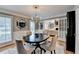 Elegant dining room with chandelier, dark wood table, neutral walls, and hardwood floors at 3045 Hartridge Dr, Johns Creek, GA 30022
