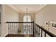 Grand two-story foyer showcases a beautiful chandelier and staircase with iron railings at 3045 Hartridge Dr, Johns Creek, GA 30022