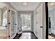 Bright hallway with hardwood floors, natural light, and views of the connecting bathroom at 3045 Hartridge Dr, Johns Creek, GA 30022