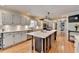 Bright and airy kitchen with a large center island, stainless appliances and hardwood floors at 3045 Hartridge Dr, Johns Creek, GA 30022