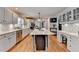 Spacious kitchen with stainless steel appliances, center island, and white cabinets at 3045 Hartridge Dr, Johns Creek, GA 30022