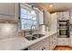 Updated kitchen boasts stainless steel appliances, dual sink, and a bright window overlooking the backyard at 3045 Hartridge Dr, Johns Creek, GA 30022