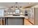 Modern kitchen with island cooktop, stainless appliances, and recessed lighting at 3045 Hartridge Dr, Johns Creek, GA 30022