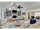 Bright living room with vaulted ceilings, a fireplace, built-in shelving, and hardwood floors at 3045 Hartridge Dr, Johns Creek, GA 30022