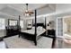 Stately main bedroom features a four-poster bed, tray ceiling, and luxurious details at 3045 Hartridge Dr, Johns Creek, GA 30022