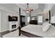 Relaxing main bedroom featuring a fireplace, four poster bed, and cozy decor at 3045 Hartridge Dr, Johns Creek, GA 30022