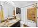 Well-lit bathroom with granite countertop vanity and tiled shower and tub at 622 Rocky Creek Pt, Woodstock, GA 30188