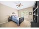 Comfortable bedroom with a large window, neutral walls, and carpet, accented with a black shelf at 622 Rocky Creek Pt, Woodstock, GA 30188