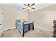 Comfortable bedroom with ceiling fan and plush carpeting at 622 Rocky Creek Pt, Woodstock, GA 30188