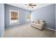 Bedroom featuring carpeted floors, a ceiling fan, two windows, and neutral walls at 622 Rocky Creek Pt, Woodstock, GA 30188