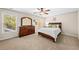 Bright bedroom featuring neutral walls, a ceiling fan, and carpet, along with a large window for ample natural light at 622 Rocky Creek Pt, Woodstock, GA 30188