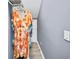 A stylish, colorful dress hangs in an organized closet at 622 Rocky Creek Pt, Woodstock, GA 30188