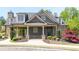 Charming clubhouse exterior with stone accents, covered porch, and beautifully landscaped grounds at 622 Rocky Creek Pt, Woodstock, GA 30188