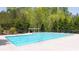 Large community swimming pool with clear blue water, surrounded by a spacious deck and lush trees at 622 Rocky Creek Pt, Woodstock, GA 30188
