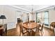 Spacious dining room boasts hardwood floors, chandelier, and window views at 622 Rocky Creek Pt, Woodstock, GA 30188