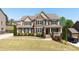 Beautiful two-story brick home with a lush front lawn and professional landscaping at 622 Rocky Creek Pt, Woodstock, GA 30188