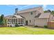 Spacious home exterior featuring a screened-in porch, well-manicured lawn, and outdoor fireplace at 622 Rocky Creek Pt, Woodstock, GA 30188
