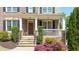 Charming brick home with a stone front porch, stairs, and attractive landscaping at 622 Rocky Creek Pt, Woodstock, GA 30188