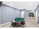 Game room with a poker table with chairs, and an adjacent kitchenette area at 622 Rocky Creek Pt, Woodstock, GA 30188