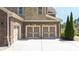 Spacious two-car garage featuring stylish doors and a clean, modern driveway at 622 Rocky Creek Pt, Woodstock, GA 30188