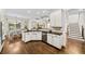 Kitchen featuring white cabinets, granite countertops, stainless appliances, and hardwood floors at 622 Rocky Creek Pt, Woodstock, GA 30188
